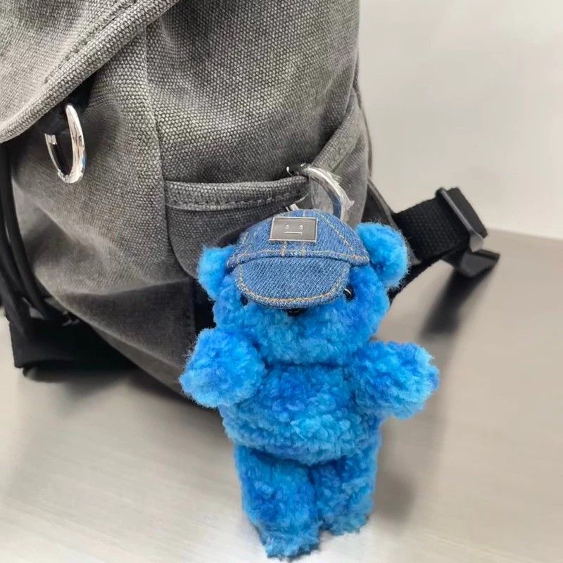 Acne Studios Blue Teddy Bear Keychain with Denim Hat (Category: Luxury Accessories) located in Manila. Submitted by connor____lee (Listing ID 1457315971, Image 2). Description: - Adorable blue teddy bear keychain from Acne Studios. - Features a cute denim hat with the signature face logo. - Includes original box and tags. - Versatile accessory for your bags or keys. - Adds a fun pop of color to your everyday items..