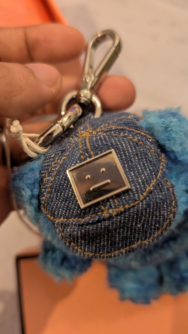 Acne Studios Blue Teddy Bear Keychain with Denim Hat (Category: Luxury Accessories) located in Manila. Submitted by connor____lee (Listing ID 1457315971, Image 3). Description: - Adorable blue teddy bear keychain from Acne Studios. - Features a cute denim hat with the signature face logo. - Includes original box and tags. - Versatile accessory for your bags or keys. - Adds a fun pop of color to your everyday items..