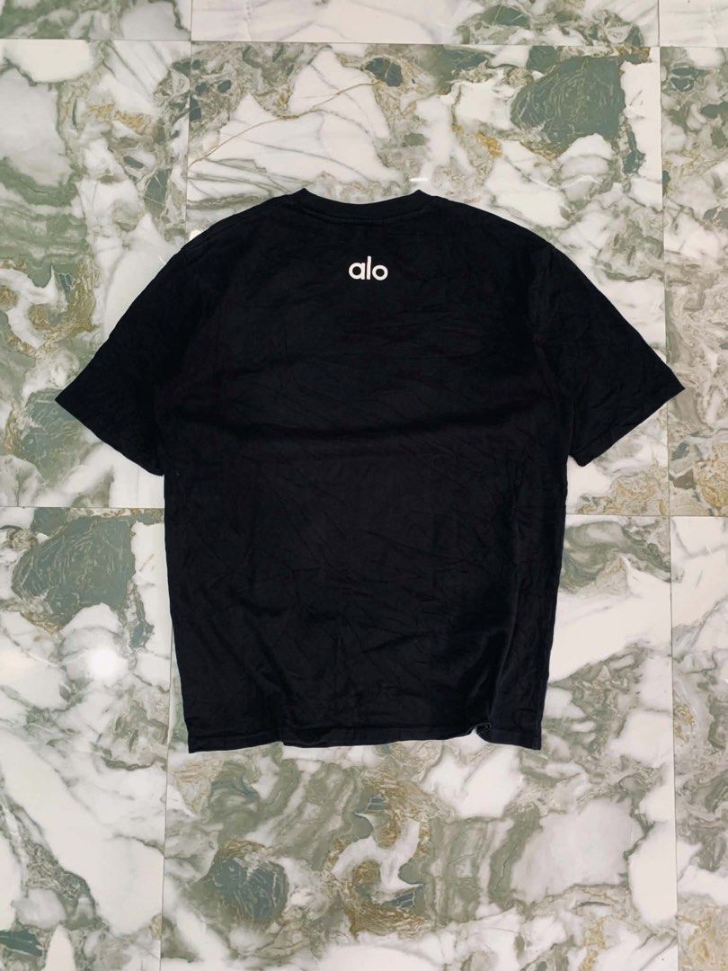 Alo Black T-shirt (Category: Tshirts & Polo Shirts ) located in Cavite. Submitted by gelloots (Listing ID 1457144895, Image 2). Description: Alo Black T-shirt. Simple logo design. Comfortable fit for everyday wear. Details: ALO Yoga Size: XS Dimes: 20x26.5 Color Rate: 9.5/10 Excellent Condition .