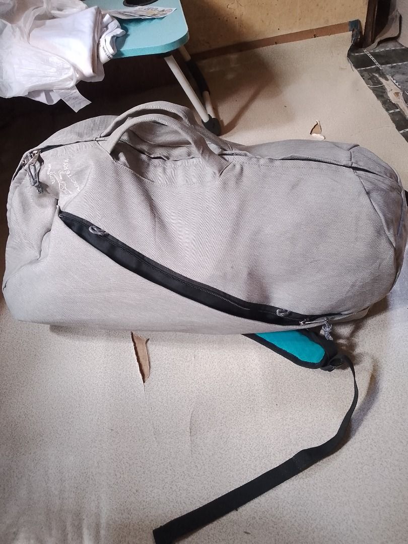 Arc'teryx Backpack Grey Duffle Bag (Category: Backpacks) located in Caloocan City. Submitted by alfepangasate1021 (Listing ID 1457149464, Image 1). Description: - Grey Arc'teryx backpack that doubles as a duffle bag. - Features a vibrant teal interior lining. - Durable black zippers. - Black and orange straps for a stylish look. - Ideal for travel, gym, or everyday use..