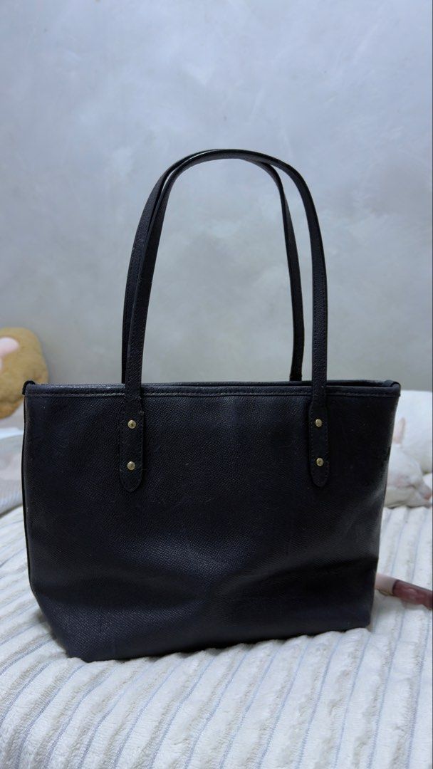 Auth Coach Mini City Zip Tote Bag (Category: Luxury Bags & Wallets) located in San Jose del Monte. Submitted by danggszz (Listing ID 1457324737, Image 2). Description: - Authentic preloved Coach Mini City Zip Tote Bag - Color: Dark Navy Blue (almost black) - Material: Leather - sticky -Dimensions Handles with 7” (17.75 cm) drop 9” L x 8” H x 4.25” W (22.75 x 20 x 10.75 cm) Please manage your expectations on this. May flaws and all napo.