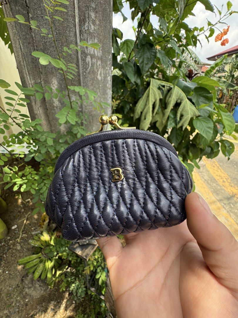 Bally Quilted Leather Coin Pouch (Category: Luxury Bags & Wallets) located in Cainta. Submitted by danica010314 (Listing ID 1457163426, Image 2). Description: - Authentic Bally coin pouch - Color: Dark navy blue - Material: Quilted leather - Closure: Gold-tone clasp - Origin: Made in Italy - Includes: Original Bally dust bag - Perfect for: Small bags or pockets.