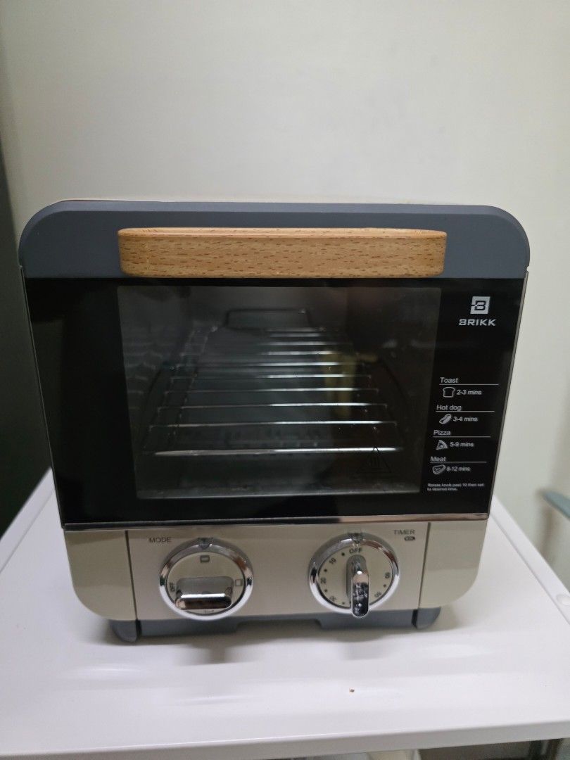 BRIKK Mini Oven with Timer and Mode Settings (Category: Ovens & Toasters) located in San Juan City. Submitted by mia.concep (Listing ID 1457255456, Image 1). Description: - Compact BRIKK mini oven - Timer and mode selection dials - Stylish wooden handle for easy opening - Interior rack included - Ideal for small kitchens or dorm rooms - Ready for a new home!.