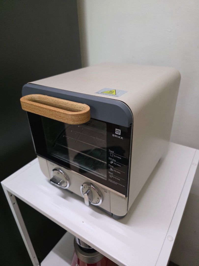 BRIKK Mini Oven with Timer and Mode Settings (Category: Ovens & Toasters) located in San Juan City. Submitted by mia.concep (Listing ID 1457255456, Image 2). Description: - Compact BRIKK mini oven - Timer and mode selection dials - Stylish wooden handle for easy opening - Interior rack included - Ideal for small kitchens or dorm rooms - Ready for a new home!.