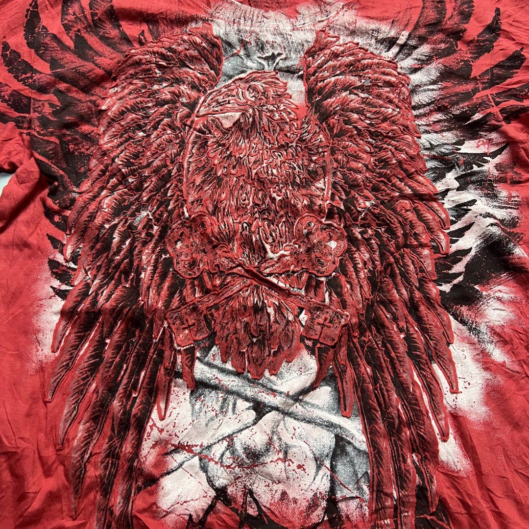 Buckaroo Red Graphic T-Shirt Eagle Wings Skull (Category: Tshirts & Polo Shirts ) located in Bago City. Submitted by g___shop (Listing ID 1457252490, Image 3). Description: - Red Buckaroo T-Shirt - Size: Medium (M) - Front Graphic: Large eagle with wings and skull design - Back Graphic: Buckaroo logo - Material: 100% Cotton - Style: Casual wear.