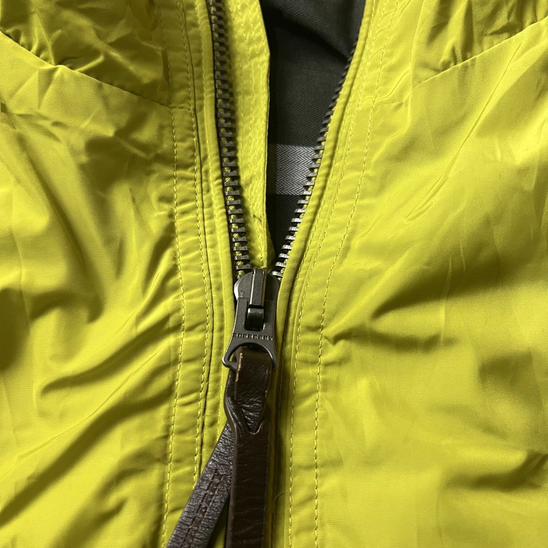 Burberry Lime Green Bomber Jacket (Category: Coats, Jackets and Outerwear) located in Bago City. Submitted by g___shop (Listing ID 1457252162, Image 3). Description: - Cool lime green bomber jacket - Iconic Burberry check lining - Zip front closure with leather pull tab - Two front pockets with button closure - Ribbed cuffs and hem for a snug fit - Ideal for layering over any outfit.