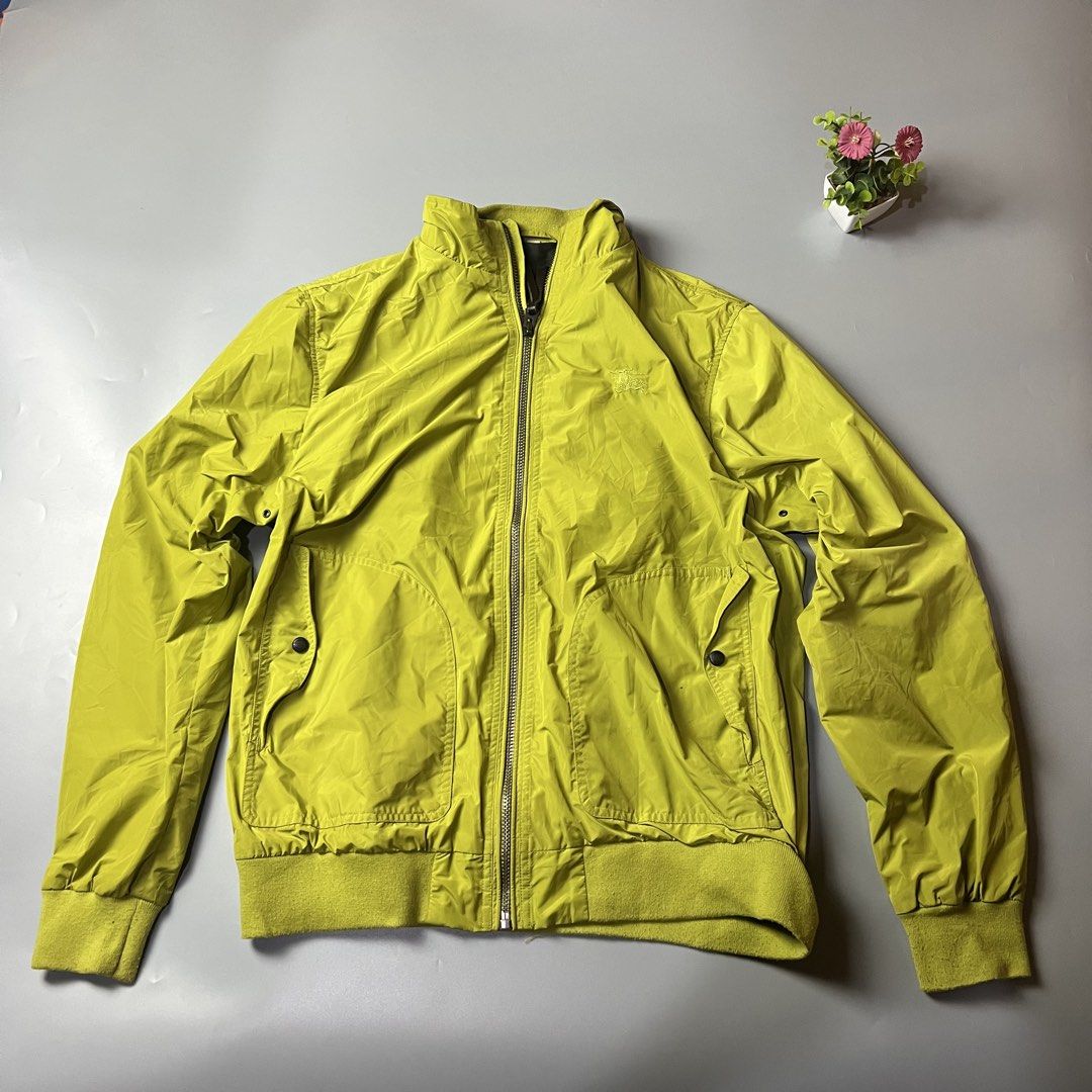 Burberry Lime Green Bomber Jacket (Category: Coats, Jackets and Outerwear) located in Bago City. Submitted by g___shop (Listing ID 1457252162, Image 1). Description: - Cool lime green bomber jacket - Iconic Burberry check lining - Zip front closure with leather pull tab - Two front pockets with button closure - Ribbed cuffs and hem for a snug fit - Ideal for layering over any outfit.