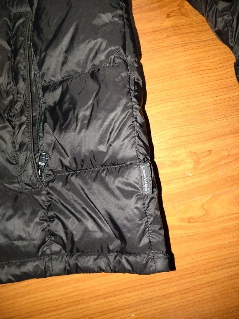 Calvin Klein Packable Lightweight Down Jacket L/G Black (Category: Coats, Jackets and Outerwear) located in Angeles City. Submitted by mightywhale_13072f (Listing ID 1457167348, Image 3). Description: - Calvin Klein Puffer Jacket - Color: Black - Size: L/G - Lightweight and packable design - Down filled for warmth - Front pockets - Full zip-up front closure - Small Calvin Klein logo detail on the side.