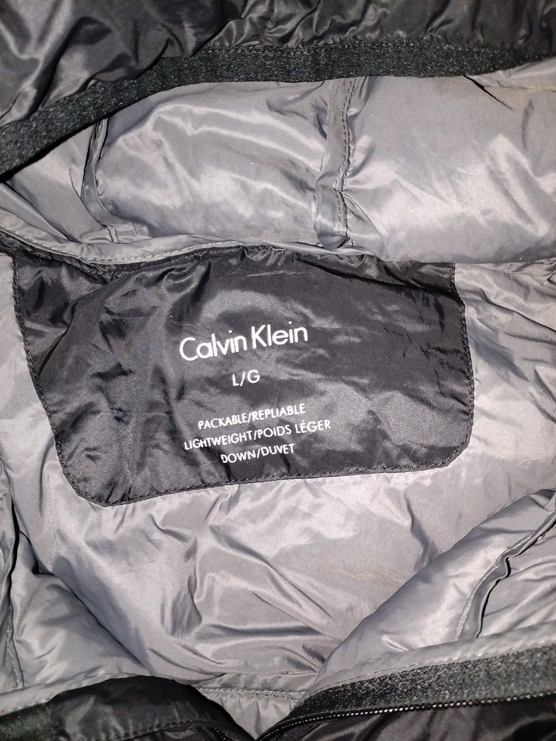Calvin Klein Packable Lightweight Down Jacket L/G Black (Category: Coats, Jackets and Outerwear) located in Angeles City. Submitted by mightywhale_13072f (Listing ID 1457167348, Image 2). Description: - Calvin Klein Puffer Jacket - Color: Black - Size: L/G - Lightweight and packable design - Down filled for warmth - Front pockets - Full zip-up front closure - Small Calvin Klein logo detail on the side.