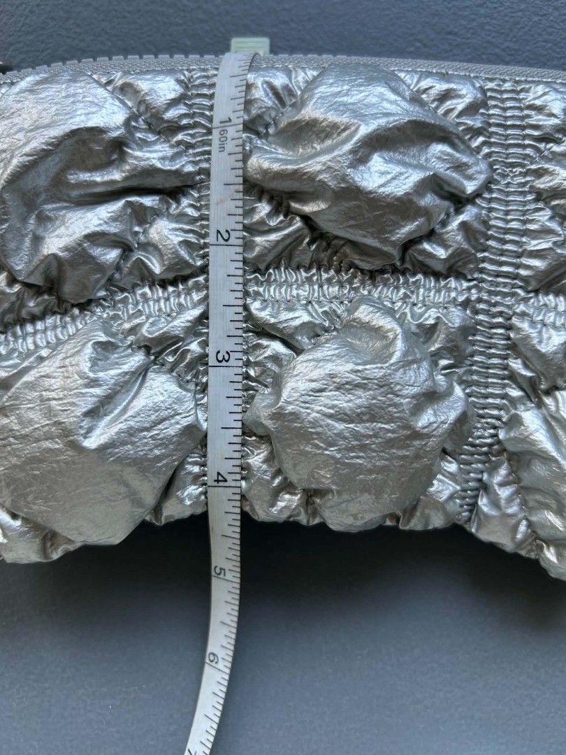 CARLYN Silver Puffy Pouch Bag (Category: Purses & Pouches) located in Calamba. Submitted by merrymerida (Listing ID 1457200878, Image 3). Description: - Cute puffy silver pouch from CARLYN - Features a crinkled texture - Ideal for small essentials (cards, cash, makeup) - Secure zipper closure - Approximate dimensions: 7" W x 4" H - Versatile use: as a clutch or bag organizer.