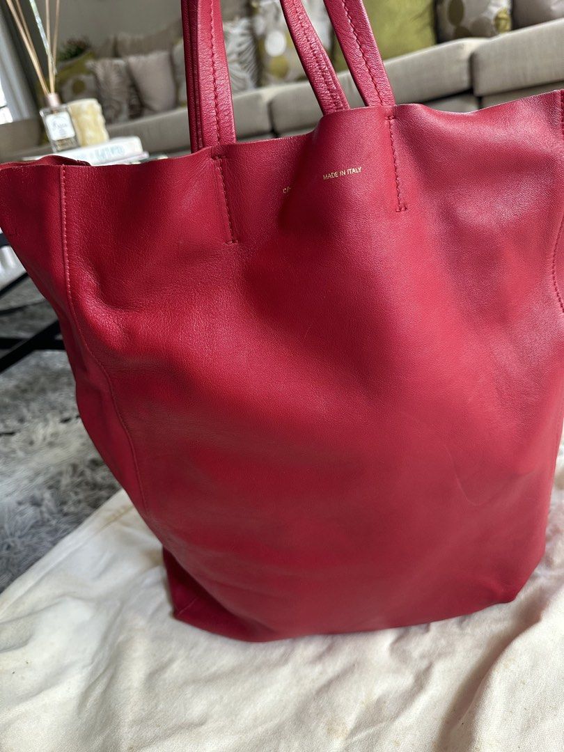 Celine Red Leather Tote Bag (Category: Luxury Bags & Wallets) located in Manila. Submitted by marmarpec (Listing ID 1457162564, Image 2). Description: - Authentic Celine tote bag - Vibrant red color - Made in Italy - Soft and supple leather - Spacious design, perfect for everyday use - Comes with original Celine dust bag - Perfect work bag or day out bag - flaw- small pen mark ( pls ref to pic).