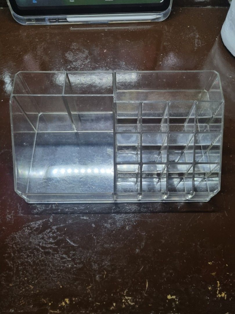 Clear Acrylic Makeup Organizer with Compartments (Category: Makeup) located in Manila. Submitted by museoftheartist (Listing ID 1457277576, Image 1). Description: - Clear acrylic organizer for makeup and cosmetics. - Multiple compartments for lipsticks, brushes, and more. - Top section features smaller slots. - Larger compartment in the bottom section. - Perfect for a tidy vanity. - Easy to clean..