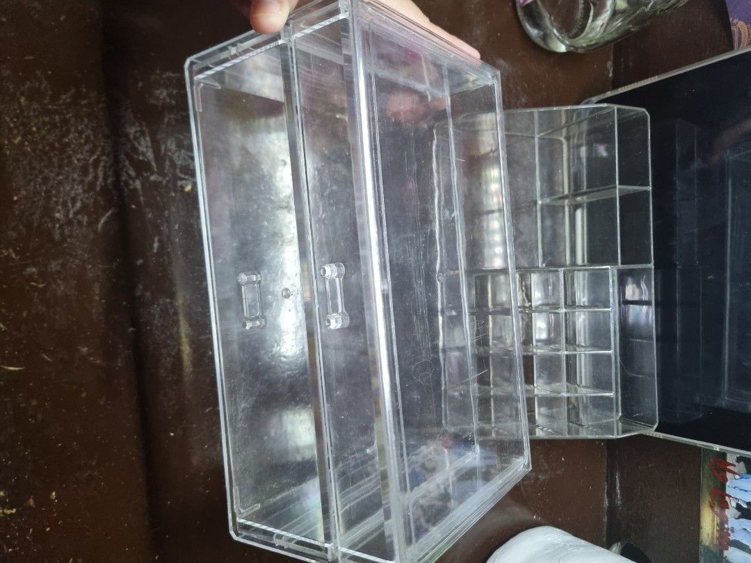 Clear Acrylic Makeup Organizer with Compartments (Category: Makeup) located in Manila. Submitted by museoftheartist (Listing ID 1457277576, Image 2). Description: - Clear acrylic organizer for makeup and cosmetics. - Multiple compartments for lipsticks, brushes, and more. - Top section features smaller slots. - Larger compartment in the bottom section. - Perfect for a tidy vanity. - Easy to clean..