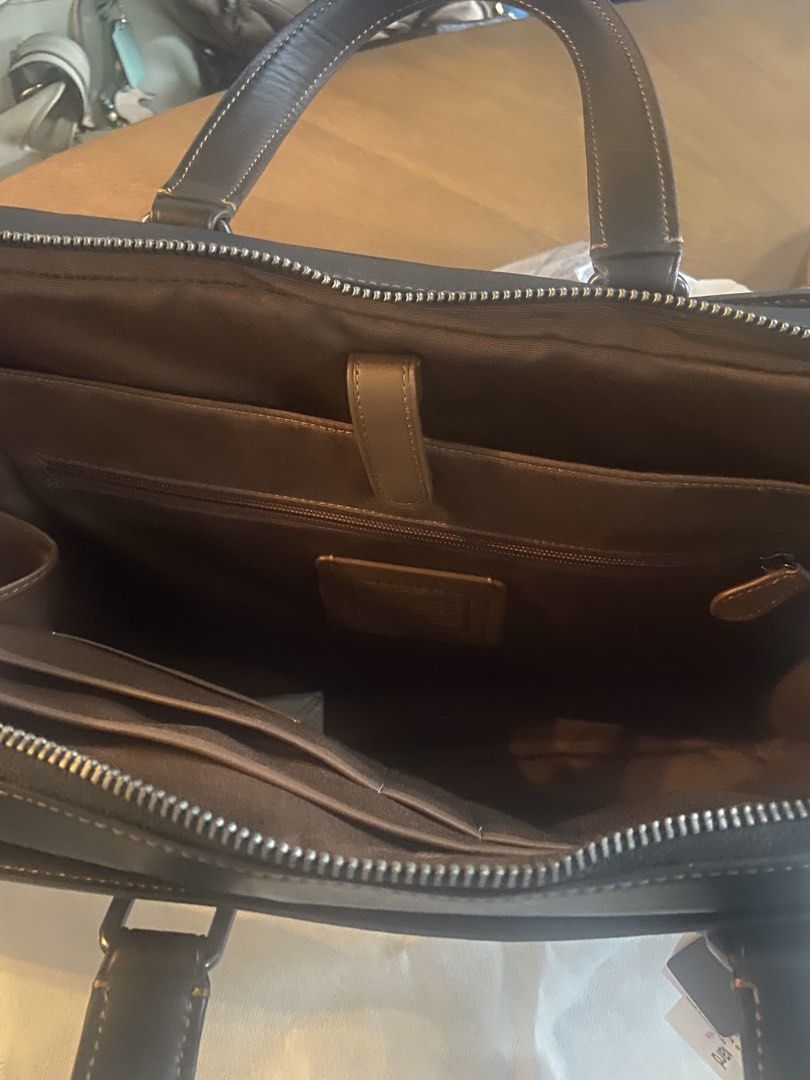 Coach laptop bag (Category: Luxury Bags & Wallets) located in Taguig. Submitted by .dons. (Listing ID 1457226613, Image 2). Description: Crossbody/ Top Handle/ Document/ Laptop Bag Front Exterior Snap Pocket Back Exterior Snap Pocket Double Leather Top Handle Straps Detachable, Adjustable Crossbody/ Shoulder Strap Zip-Around Closure 1 Multi-Function Slip Pocket for Laptop/ Tablet 1 Interior Zip Pocket; 3 Interior Slip Pockets 2 Pen Holder Slip Po