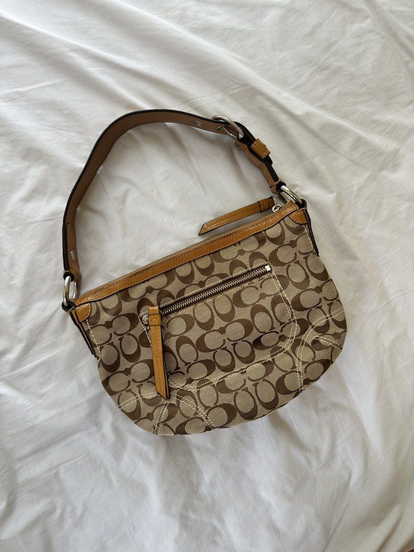 Coach Soho Hobo Bag (Category: Luxury Bags & Wallets) located in Manila. Submitted by lily.28 (Listing ID 1457195825, Image 2). Description: - Classic Coach monogram hobo bag - Tan and brown canvas with leather trim - Zipper closure - Front zip pocket - Adjustable strap - Great everyday bag - Fits essentials.