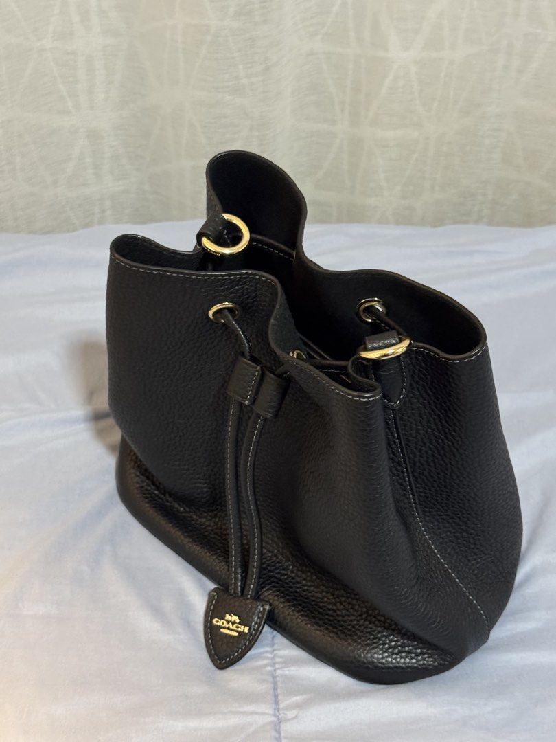 Coach Rowan bucket bag (Category: Luxury Bags & Wallets) located in Las Pinas. Submitted by makiyan_ (Listing ID 1457260299, Image 3). Description: - Authentic Coach black pebbled leather bucket bag - Gold hardware - Comes with a matching monogrammed pouch - Adjustable strap.