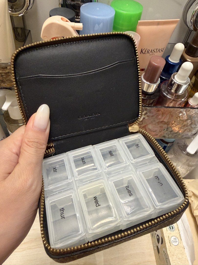 Coach Pill Organizer (Category: Luxury Bags & Wallets) located in Manila. Submitted by troddetrading (Listing ID 1457148888, Image 3). Description: - Authentic Coach monogram pill pouch - Features a convenient weekly pill organizer with daily compartments - Secure zipper closure - Ideal for travel and daily organization - Compact and portable design.