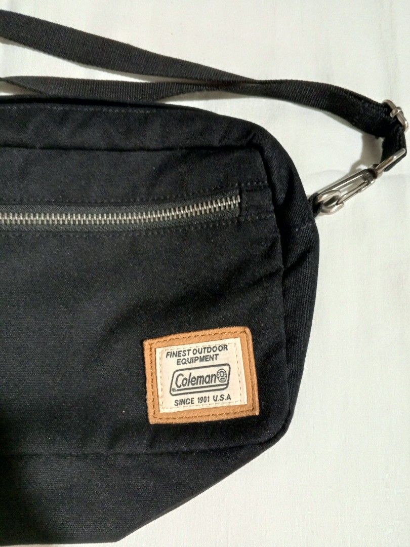 Coleman Black Canvas Crossbody Bag (Category: Accessory Holder, Box & Organizers) located in Castillejos. Submitted by eross07 (Listing ID 1457250266, Image 2). Description: - Brand: Coleman - Color: Black - Material: Canvas - Style: Crossbody bag - Features: Zippered front pocket, main compartment, leather accents, adjustable strap, Coleman tag detail - Origin: Made in Vietnam - Ideal for: Everyday use, travel.