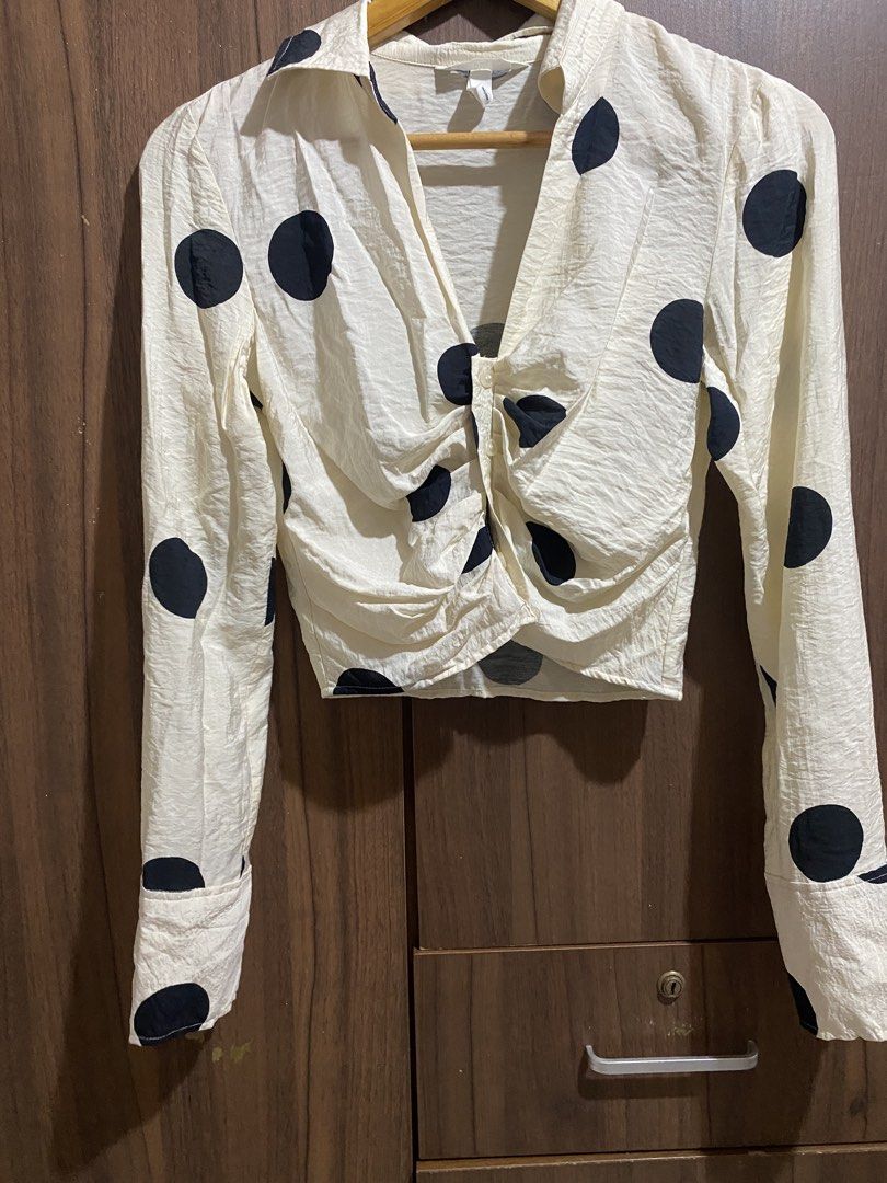 Cream Polka Dot Ruched Cropped Shirt (Category: Shirts) located in Cebu City. Submitted by mickaaay (Listing ID 1457261509, Image 3). Description: - Cream long-sleeved shirt - Black polka dot pattern - Ruched front detail - Button closure - Cropped length - Textured fabric finish - Versatile for casual or dressed-up outfits.