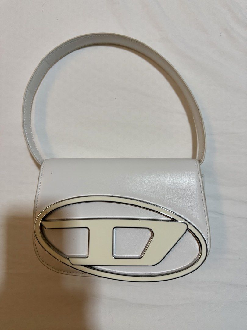 Diesel 1DR Nappa Leather Shoulder Bag (Category: Luxury Bags & Wallets) located in Quezon City. Submitted by venezia13 (Listing ID 1457323631, Image 1). Description: - White shoulder bag from Diesel - Comes with a long strap and a dustbag - Used once no damage.