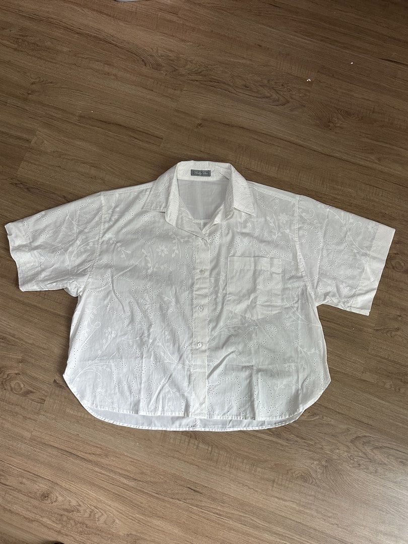 Eyelet Button down shirt (Category: Blouses) located in Taguig. Submitted by declutterkweeen (Listing ID 1457254179, Image 1). Description: Eyelet button down shirt from BKK Never worn, only washed. Can fit S-L, as normal top or even like a cover up for the beach. RFS: impulse buy, not really being used since I have similar tops..