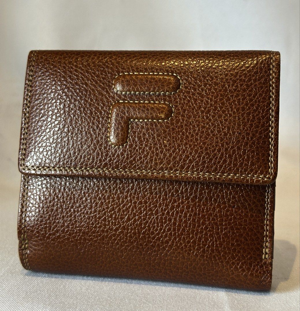 FILA Brown Leather Bifold Wallet (Category: Luxury Bags & Wallets) located in Manila. Submitted by originalvintagebagph (Listing ID 1457309041, Image 2). Description: - Brand: Fila - Material: Brown Textured Leather - Design: Bifold Wallet - Features: Stitched detailing, multiple interior card slots, snap closure - Style: Classic, compact, ideal for everyday use.