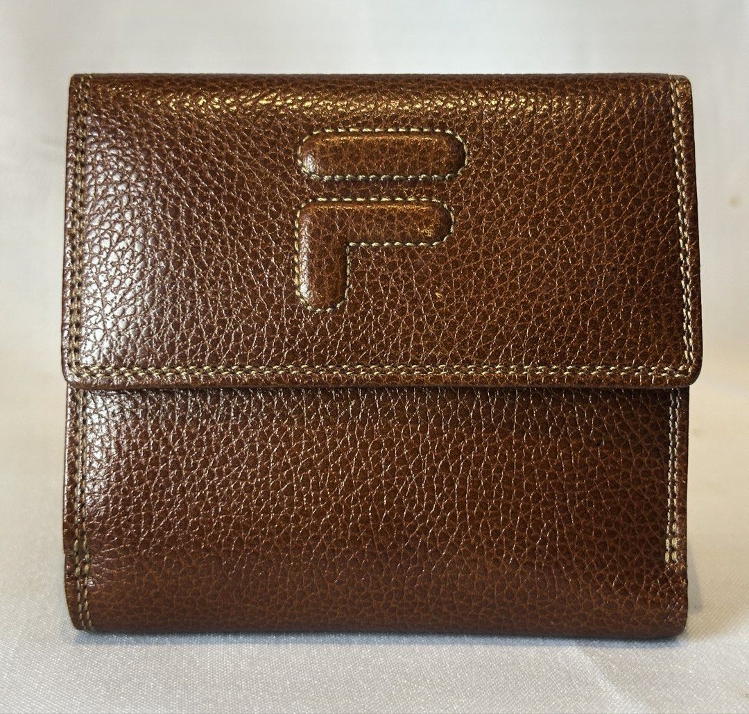 FILA Brown Leather Bifold Wallet (Category: Luxury Bags & Wallets) located in Manila. Submitted by originalvintagebagph (Listing ID 1457309041, Image 1). Description: - Brand: Fila - Material: Brown Textured Leather - Design: Bifold Wallet - Features: Stitched detailing, multiple interior card slots, snap closure - Style: Classic, compact, ideal for everyday use.