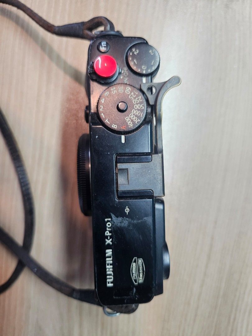 Fujifilm X-Pro1 Camera with Various Accessories (Category: Cameras) located in Paranaque City. Submitted by wapra (Listing ID 1457244471, Image 3). Description: - Fujifilm X-Pro1 Digital Camera - Original Box Included - Genuine Hand Grip - Original Charger - Two (2) Batteries - JJC LH-JX100FU Lens Hood Adapter - Strap Attached - Minor cosmetic scuffs on camera body - All items pictured are included.