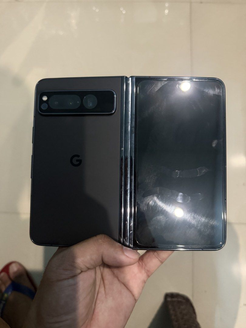 Google Pixel Fold 256GB - FU (Category: Google Pixel) located in San Juan City. Submitted by maaaarrky (Listing ID 1457250488, Image 2). Description: Google Pixel Fold - Black 256GB Condition: 99% Smooth With Box, unused cord and 3 cases Specs: - Display: 7.6” OLED Foldable 120Hz + 5.8” Outer Display - Processor: Google Tensor G2 - Camera: 48MP Main + Ultra-wide + Telephoto - Battery: 4821mAh, 30W charging - Other: IPX8 Water Resistant, Wireless 
