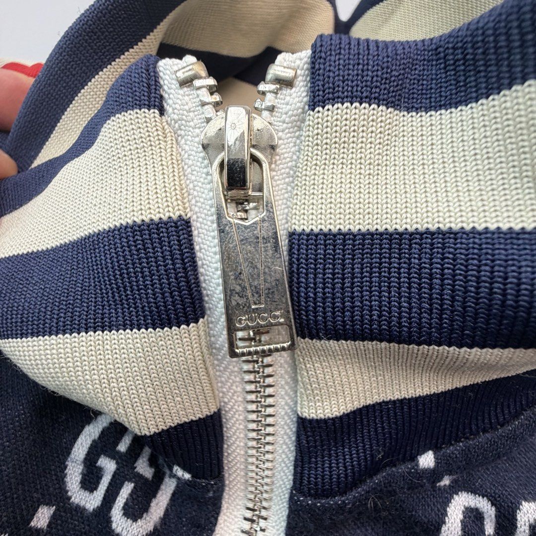 Gucci GG Monogram Web Stripe Track Jacket Navy 3XL (Category: Luxury Apparel) located in San Juan City. Submitted by vc828 (Listing ID 1457244087, Image 3). Description: Gucci full-zip track jacket featuring an all-over interlocking GG monogram design in navy and cream with the signature red and cream Web stripe running down both sleeves. Statement piece with striped rib-knit stand collar, cuffs and hem, full front zip closure, and Gucci-engraved