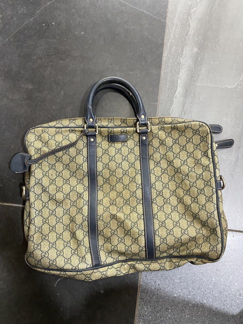 Gucci Monogram Canvas Leather Trimmed Briefcase (Category: Luxury Bags & Wallets) located in Alburquerque. Submitted by zanegavynn43872 (Listing ID 1457159223, Image 2). Description: - Gucci monogram canvas briefcase authentec not guarantee - Dark blue leather trim and handles - Canvas interior lining - Zipper closure with Gucci branded pull - Made in Italy - Serial number: 201430 130088 - Ideal for work or travel.