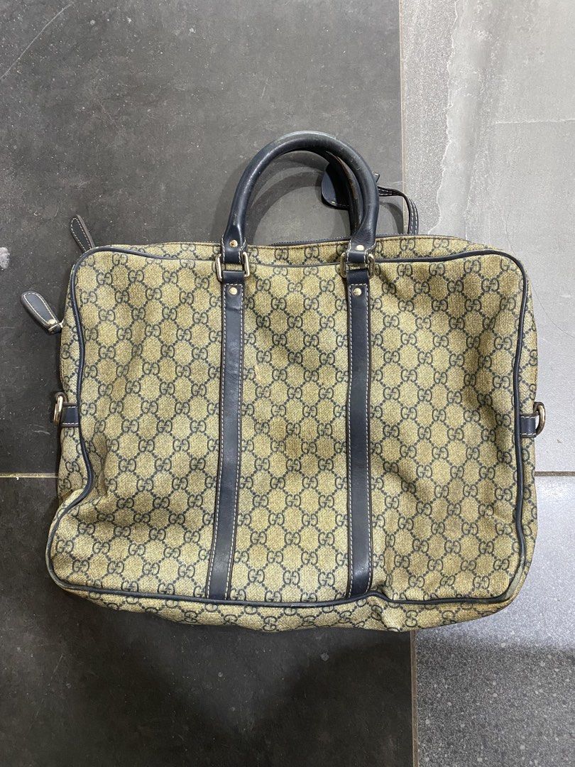 Gucci Monogram Canvas Leather Trimmed Briefcase (Category: Luxury Bags & Wallets) located in Alburquerque. Submitted by zanegavynn43872 (Listing ID 1457159223, Image 1). Description: - Gucci monogram canvas briefcase authentec not guarantee - Dark blue leather trim and handles - Canvas interior lining - Zipper closure with Gucci branded pull - Made in Italy - Serial number: 201430 130088 - Ideal for work or travel.