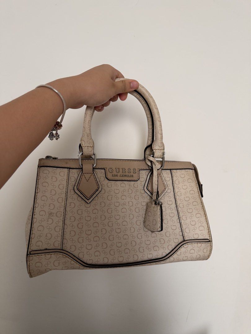Guess Aviana Satchel Bag (Category: Luxury Bags & Wallets) located in Manila. Submitted by miyadeguz64746 (Listing ID 1457217576, Image 1). Description: - Classic Guess satchel bag - Oink with all-over GG monogram print - Tan accents and handles - Zipper closure - Small tag detail - Great everyday bag.