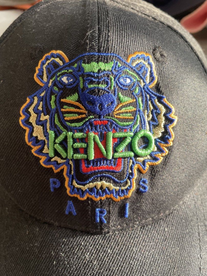 Kenzo Paris Tiger Embroidered Black Baseball Cap (Category: Caps & Hats) located in Santa Barbara. Submitted by frryt (Listing ID 1457171450, Image 2). Description: - Authentic Black Kenzo Cap - Iconic Tiger Embroidery with 'PARIS' text on front - Kenzo Logo on back strap and inside - Adjustable strap for a comfortable fit - Ideal for everyday wear.