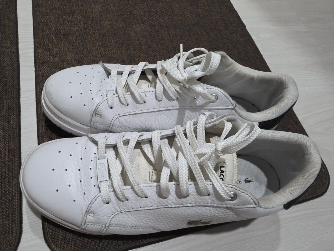 Lacoste White Leather Sneakers with Crocodile Logo (Category: Sneakers) located in Quezon City. Submitted by potion_slayer32 (Listing ID 1457149782, Image 2). Description: - White leather Lacoste sneakers - Iconic green crocodile logo on the side - Perforated details on the toe box - Striped accent on the heel - White laces - Ideal for casual wear - No box. I bought these from AU.