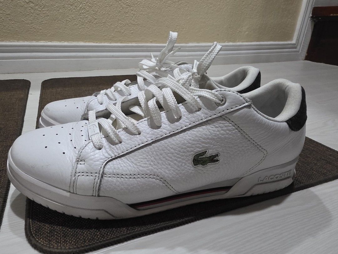 Lacoste White Leather Sneakers with Crocodile Logo (Category: Sneakers) located in Quezon City. Submitted by potion_slayer32 (Listing ID 1457149782, Image 1). Description: - White leather Lacoste sneakers - Iconic green crocodile logo on the side - Perforated details on the toe box - Striped accent on the heel - White laces - Ideal for casual wear - No box. I bought these from AU.