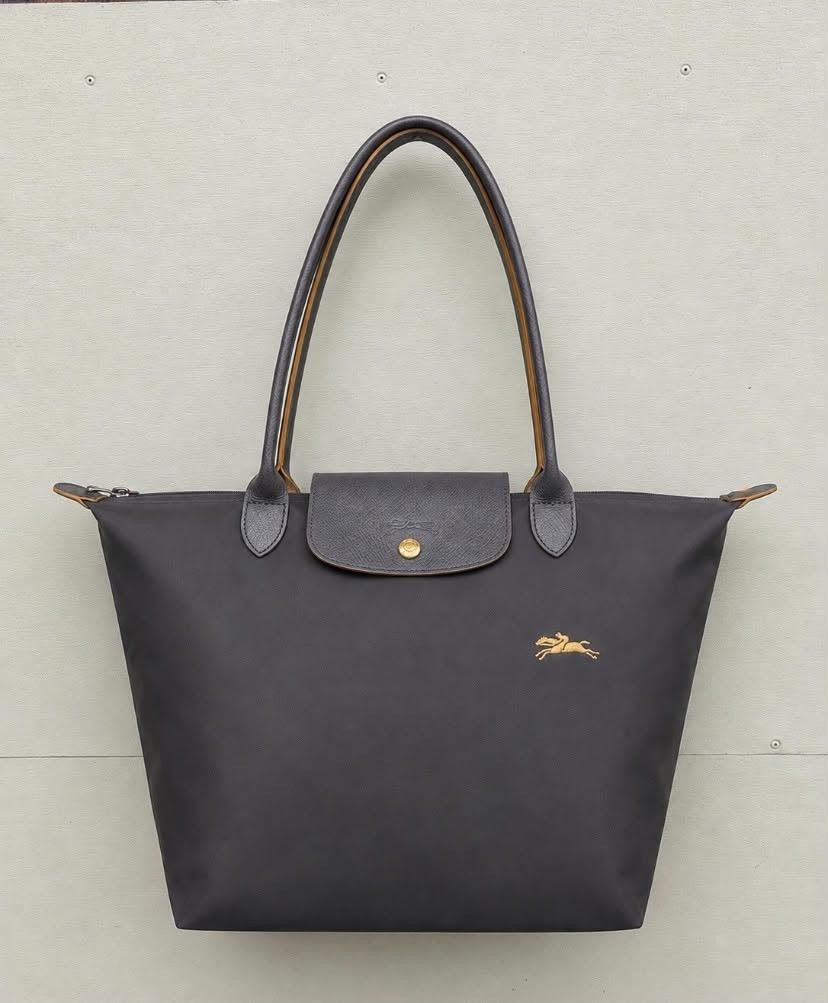 Longchamp Le Pliage Tote Bag (Category: Luxury Bags & Wallets) located in Butuan. Submitted by atab63699 (Listing ID 1457214656, Image 1). Description: - Classic Longchamp tote bag - Durable nylon with leather trim - Features iconic horse logo - Zip closure with snap-button flap - Spacious interior for essentials - Ideal for everyday use.