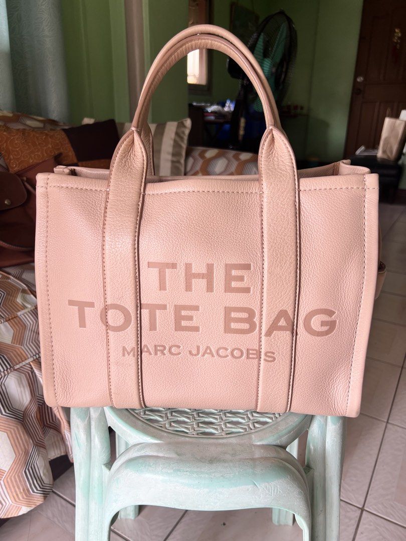 Marc Jacobs The Tote Bag (Category: Luxury Bags & Wallets) located in Quezon City. Submitted by trisha_1998 (Listing ID 1457201816, Image 1). Description: - Authentic Marc Jacobs The Tote Bag - Color: Light pink/nude - Material: Genuine Leather - Signature embossed logo on front - Embossed patch on back - Zipper closure - Spacious interior - Ideal for everyday use - in very good condition.