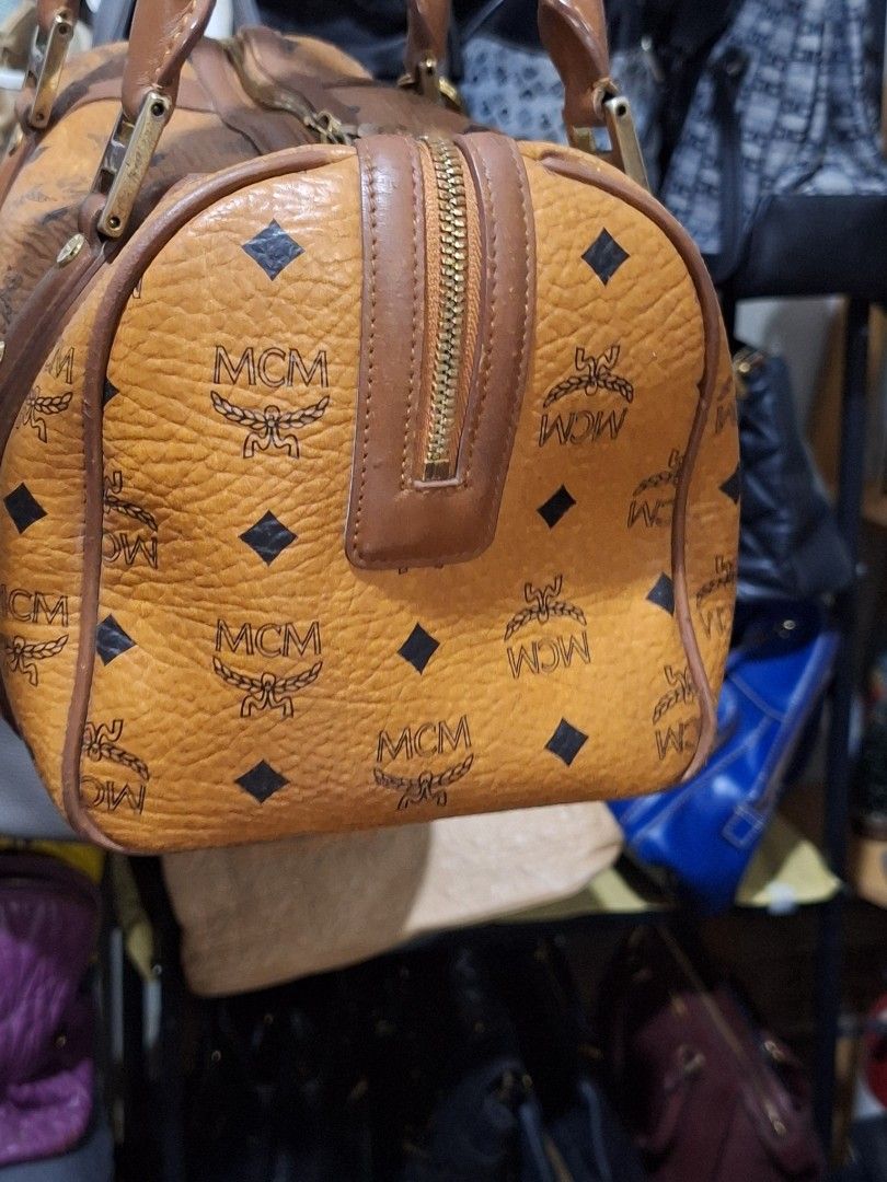 MCM Monogram Canvas Leather Trim Boston Bag (Category: Luxury Bags & Wallets) located in Quezon City. Submitted by cloudymay (Listing ID 1453807264, Image 2). Description: - Classic MCM Boston bag - Iconic monogram print on canvas - Brown leather trim - Gold-tone hardware - Zipper closure - Great everyday bag.