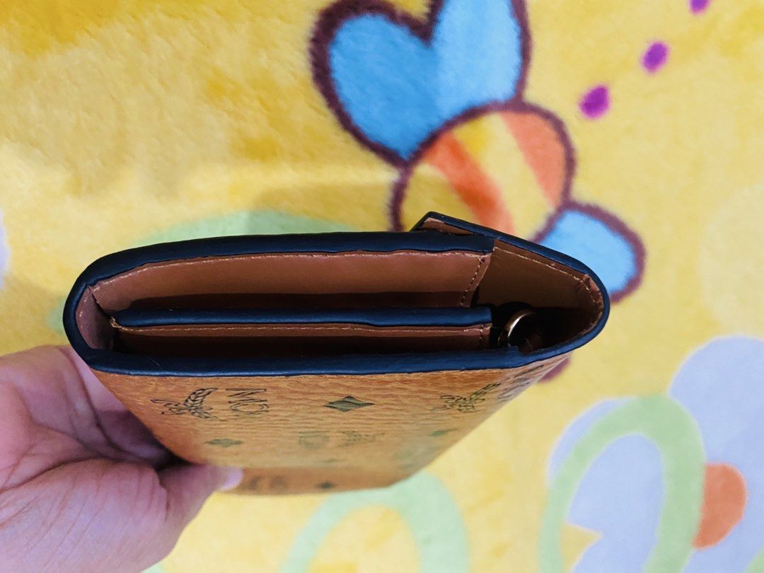 MCM Visetos Trifold Wallet Cognac (Category: Luxury Bags & Wallets) located in San Jose del Monte. Submitted by cityhanter007 (Listing ID 1457264852, Image 3). Description: - Authentic MCM wallet - Signature Visetos print - Gold-tone lock closure - Multiple card slots - Genuine leather interior - flaws: minimal fadings on hardware and may konting bakbak sa loob ng bag.