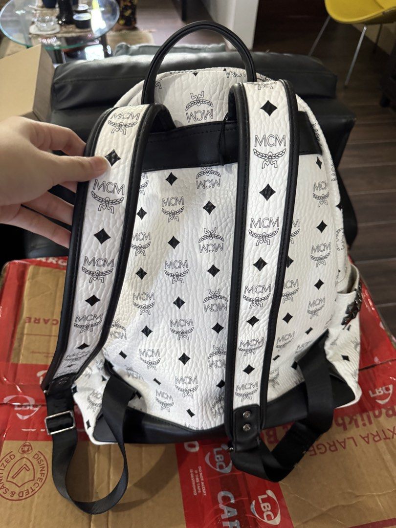 MCM White Large Backpack (Category: Luxury Bags & Wallets) located in Bulacan. Submitted by alshopie (Listing ID 1457307378, Image 2). Description: - White large MCM backpack with classic black monogram pattern. - Features a convenient top handle and adjustable shoulder straps. - Includes a front zip pocket for quick access to essentials. - Spacious interior offers ample storage. - Ideal for everyday use or your next travel adventure..