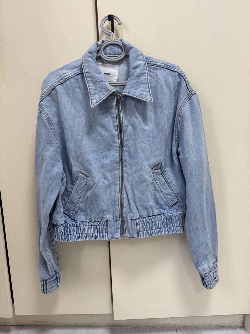 MNG Light Wash Denim Bomber Jacket (Category: Coats, Jackets and Outerwear) located in Pasig City. Submitted by petals_and_peaches (Listing ID 1457170969, Image 1). Description: - MNG light wash denim bomber jacket - Elasticated cuffs and hem - Zip-up front closure - Two front pockets - Versatile for casual outfits - Made in Pakistan.