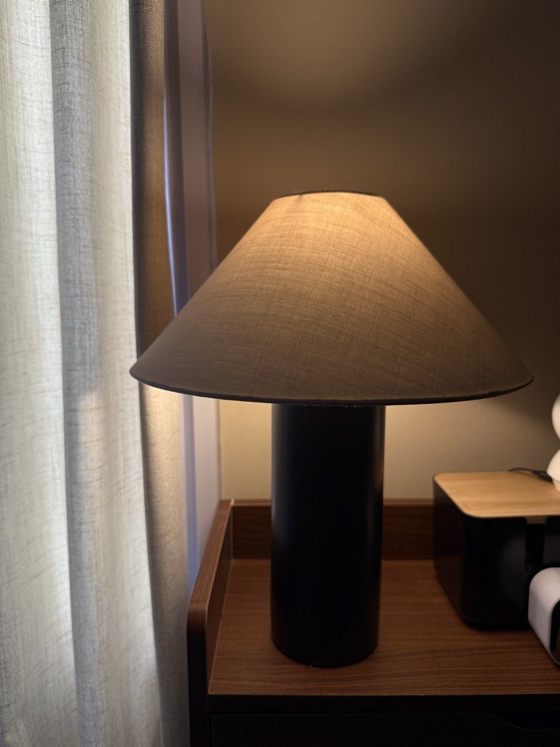Modern Black Cylinder Table Lamp with Fabric Shade (Category: Lighting) located in Las Pinas. Submitted by mitchy.ness (Listing ID 1457329411, Image 1). Description: - Stylish bedside lamp - Black cylindrical base - Neutral fabric shade - Provides warm, ambient lighting - Perfect for nightstand or side table - Adds a cozy feel.