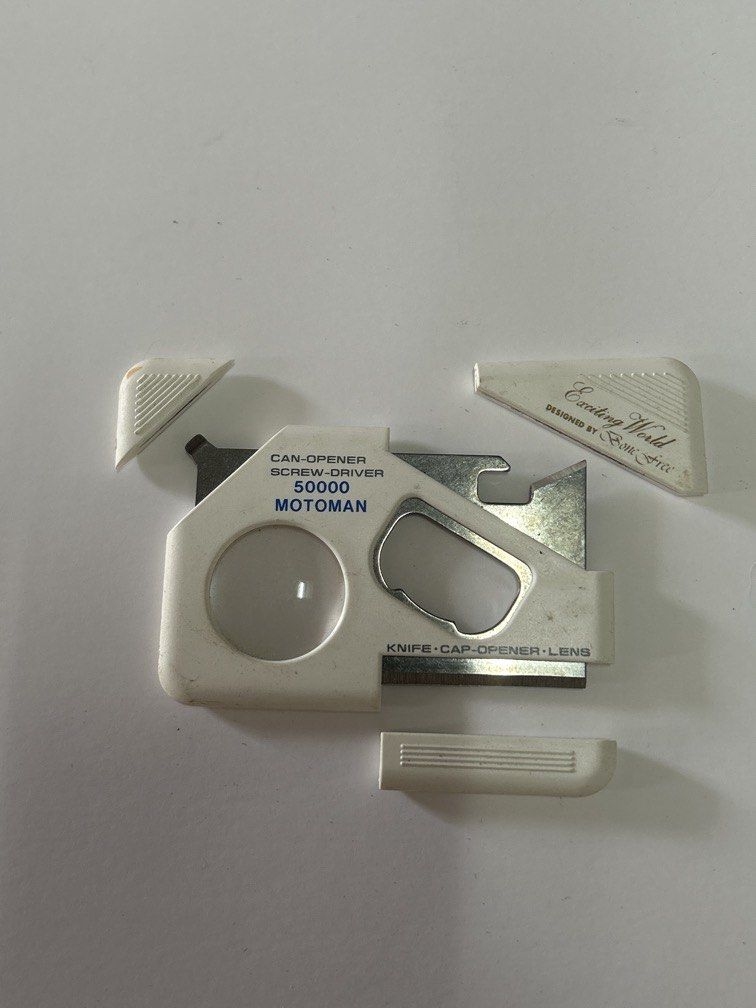 Motoman 50000 6-in-1 pocket multi-tool (Category: Wallets & Card Holders) located in Bulacan. Submitted by ourdailybreads (Listing ID 1457191868, Image 2). Description: It features an ultra-flat, wallet-friendly plastic frame housing several slide-out and built-in utility functions: Can Opener Screwdriver Small Knife Cap Opener (Bottle Opener) Magnifying Lens.