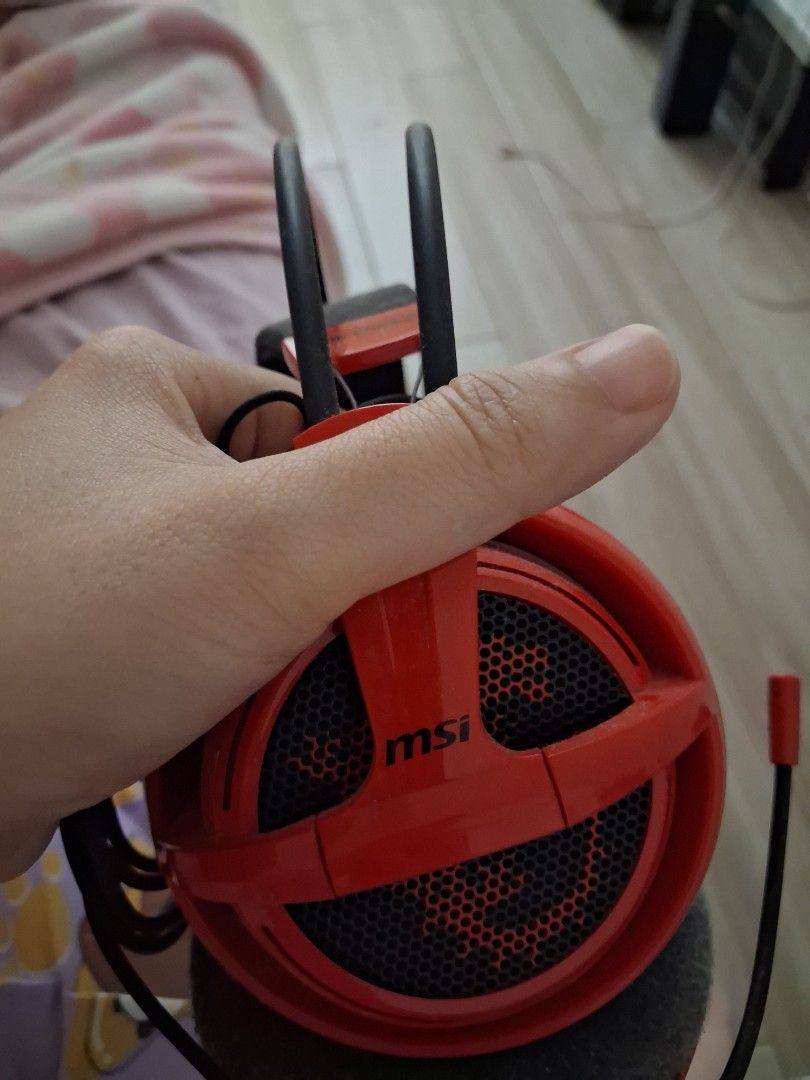MSI Red Gaming Headphones (Category: Headphones & Headsets) located in Guagua. Submitted by lavieestviah (Listing ID 1457173071, Image 2). Description: - Red MSI Gaming Headphones - Comfortable over-ear design with padded headband - Stylish mesh earcups featuring the MSI logo -Decluttering stuffs - Perfect for immersive gaming sessions or enjoying your favorite music - Shows some signs of wear on the earcups but still WORKING GOOD.