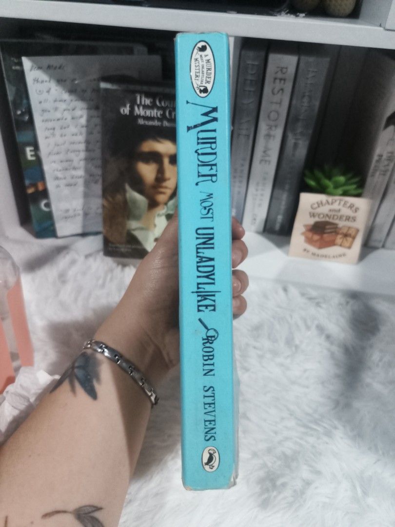 Murder Most Unladylike by Robin Stevens (Category: Storybooks) located in Cabuyao City. Submitted by chaptersandwonders143 (Listing ID 1457209404, Image 3). Description: - Title: Murder Most Unladylike by Robin Stevens - Genre: Mystery novel for young readers - Condition: Pages are yellowed from age - Cover: Some marks on the edges - Spine: Intact - Ideal for: Fans of detective stories.