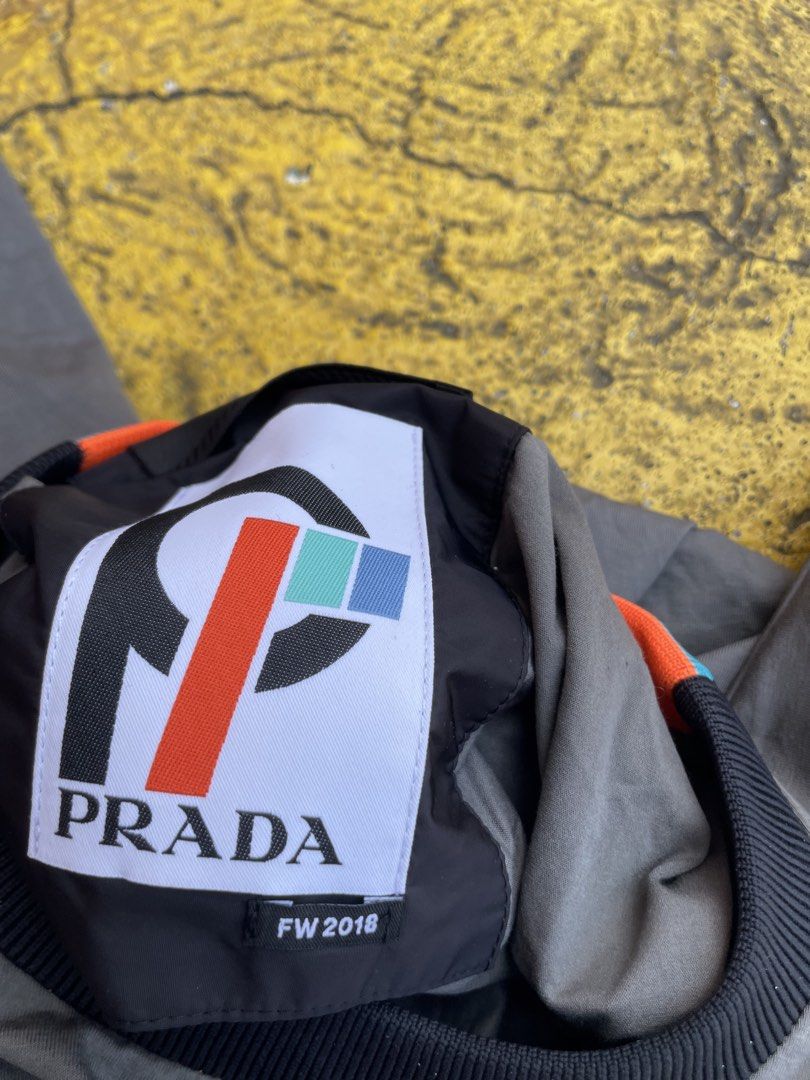 Prada shirt (Category: Luxury Apparel) located in Alegria. Submitted by deniseeee.21 (Listing ID 1457215350, Image 2). Description: flaws: see pictures Size small fit to large and xl crack prints.