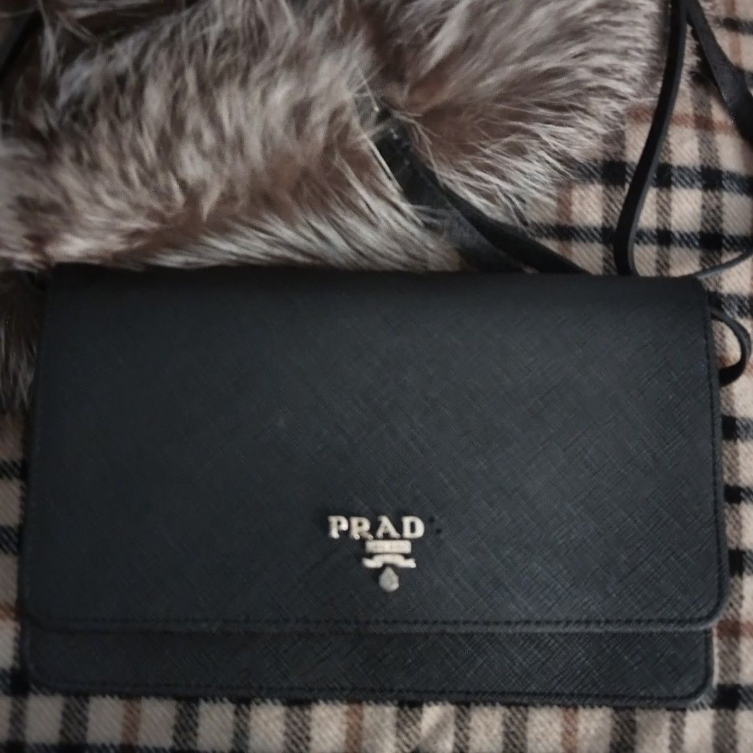Prada Sling Wallet Saffiano Leather (Category: Luxury Bags & Wallets) located in Bulacan. Submitted by brandedbagspreloved (Listing ID 1457221655, Image 3). Description: authentic coded my issue "missing A" kayo na magpagawa pls check photos for details kayo na magpagawa for personal use only korea bought last price posted plus shipping.