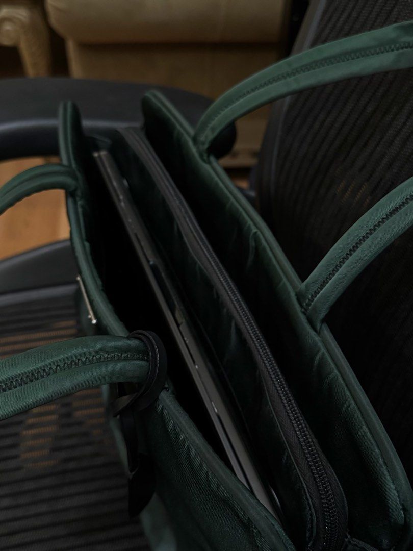 Prada Tessuto Nylon Tote Bag Dark Green (Category: Luxury Bags & Wallets) located in Manila. Submitted by ishimika (Listing ID 1457190863, Image 2). Description: - Authentic Prada dark green nylon tote bag - Spacious interior with a zippered compartment - Ideal for essentials or a laptop - Comes with original keys and lock - Sturdy and comfortable handles - Classic Prada design.