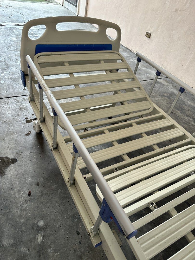Primaplus Adjustable Hospital Bed 2 Cranks (Category: Medical Supplies & Tools) located in Paranaque City. Submitted by syntaxcode (Listing ID 1457146876, Image 3). Description: Primaplus brand Hospital Bed 2 Cranks - Adjustable, Mobile wheels Well used 8/10 condition, paint chipping sa side rail guards and metal parts. Overall usable and working. Includes IV rod stand, food tray - Adjustable hospital bed for comfort and ease of use. - Features s
